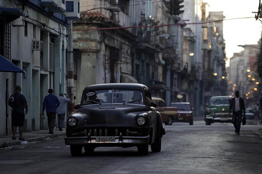 A car used as a taxi drives through the streets of Havana Dec 19, 2014.&nbsp;Cuba's parliament on Friday unanimously ratified a deal reached between Havana and Washington normalising relations after a half-century of hostility. -- PHOTO: REUTERS