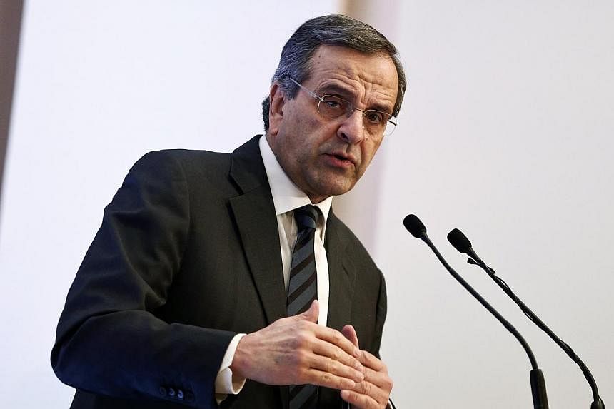 Prime Minister Antonis Samaras (above) said he would sue a popular comedian-turned-lawmaker who claimed he was offered money to help rig the presidential vote, allegedly on the premier's orders. -- PHOTO: REUTERS
