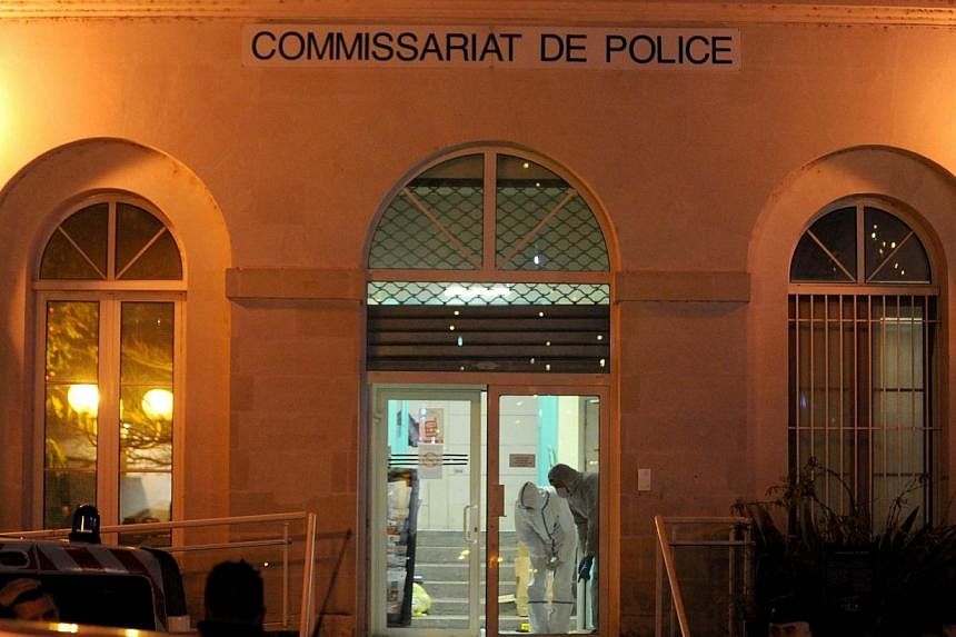 Forensic police collect evidence inside the police station of Joue les-Tours on Dec 20, 2014 where French police shot dead a man who attacked them with a knife while shouting "Allahu Akbar" ("God is great" in Arabic).&nbsp;Security was stepped up at 