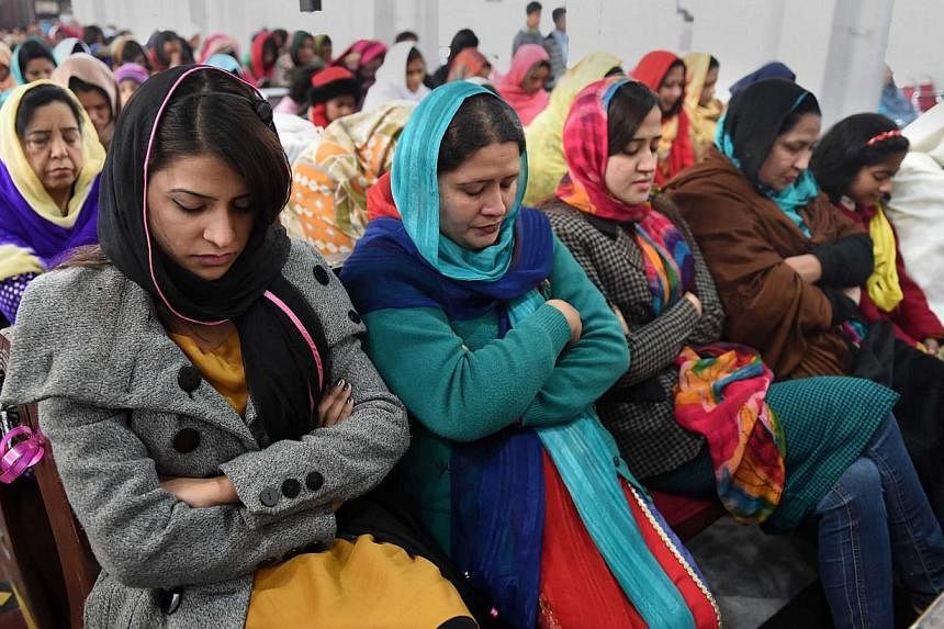 Pakistani Christians pray for the victims of the Peshawar school massacre at St. John's Cathedral in Peshawar on Dec 21, 2014. -- PHOTO: AFP