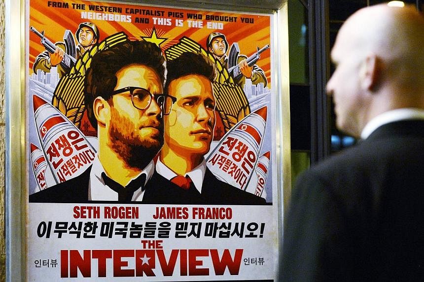 A security guard stands at the entrance of United Artists theater during the premiere of the film The Interview in Los Angeles, California in this Dec 11, 2014 file photo. -- PHOTO: REUTERS