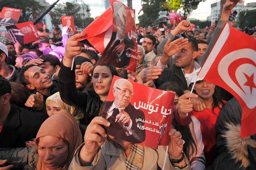 Supporters of Tunisian presidential candidate Beji Caid Essebsi attend his last meeting on Dec 19, 2014, on the Avenue Bourguiba in Tunis.&nbsp;Tunisians voted on Sunday, Dec 21, in the runoff of the first free presidential election in the North Afri