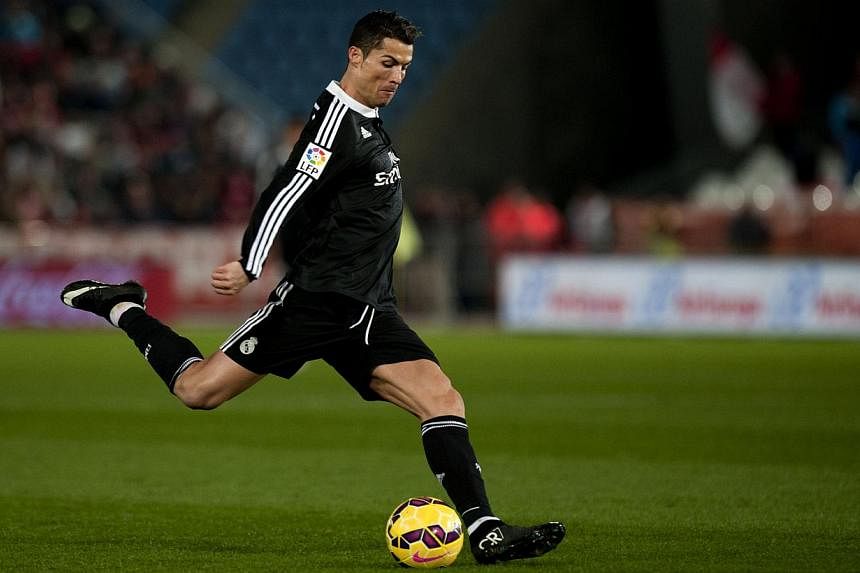 Real Madrid's Portuguese forward Cristiano Ronaldo kicks the ball during the Spanish league football match against UD Almeria on Dec 12, 2014, at Juegos Mediterraneos stadium in Almeria.&nbsp;Ronaldo, the World Player of the Year, returned to his hom