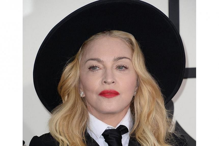 Madonna (above) on Saturday suddenly released six new songs months ahead of schedule, upset that early versions had leaked online. -- PHOTO: AFP