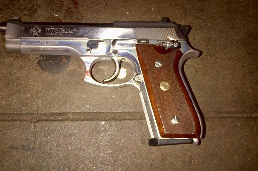 A silver semi-automatic Taurus firearm, which police said was recovered on the subway platform near the body of 28-year-old shooting suspect Ismaaiyl Brinsley. -- PHOTO: REUTERS