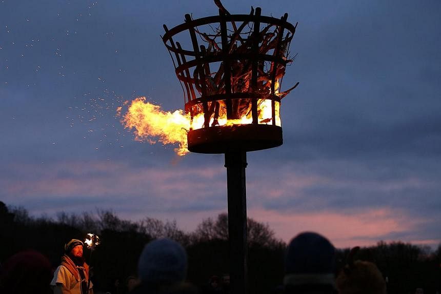 A gathering for a winter solstice ritual to mark the shortest day's sunlight on Beacon Hill near Loughborough, central England, on Dec 21, 2014. -- PHOTO: REUTERS