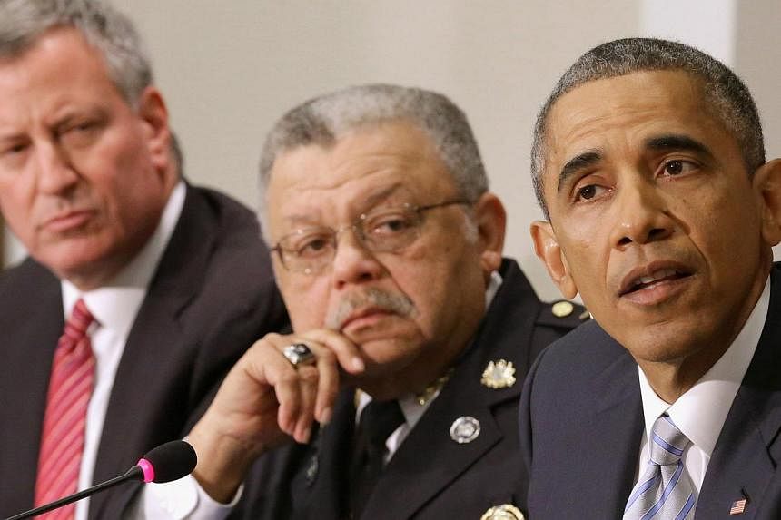 Mr Barack Obama during a meeting with (from left) New York Mayor Bill de Blasio and Philadelphia Police Department Commissioner Charles Ramsey on Dec 1, 2014 in Washington, DC. Mr Obama called Mr Charles Ramsey on Sunday to express his outrage over t