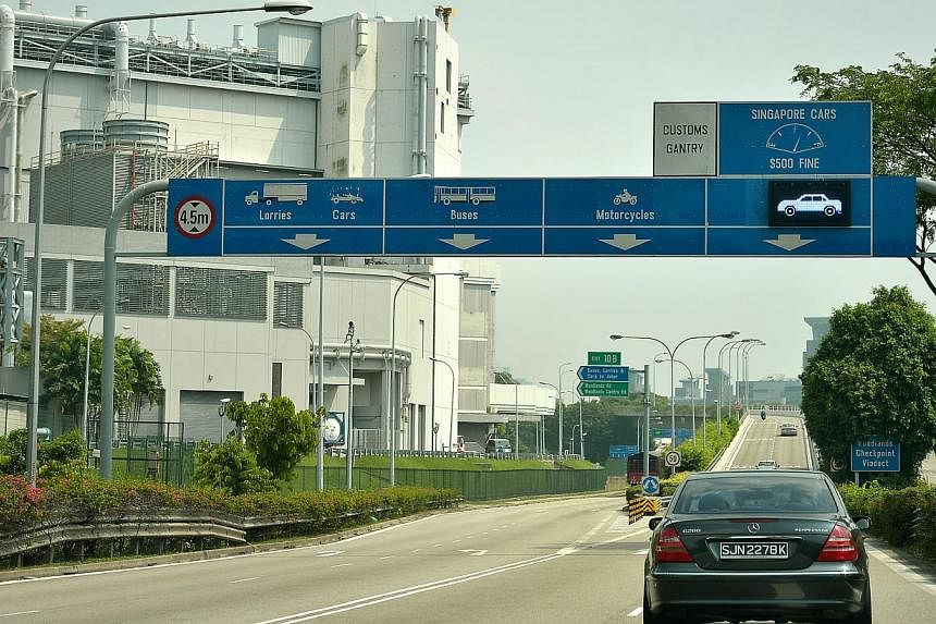 The Ministry of Transport is studying Malaysia's new levy on foreign-registered vehicles going into the country from Singapore, and will decide on a response "in due course", it said on Monday, Dec 22, 2014. -- ST FILE PHOTO
