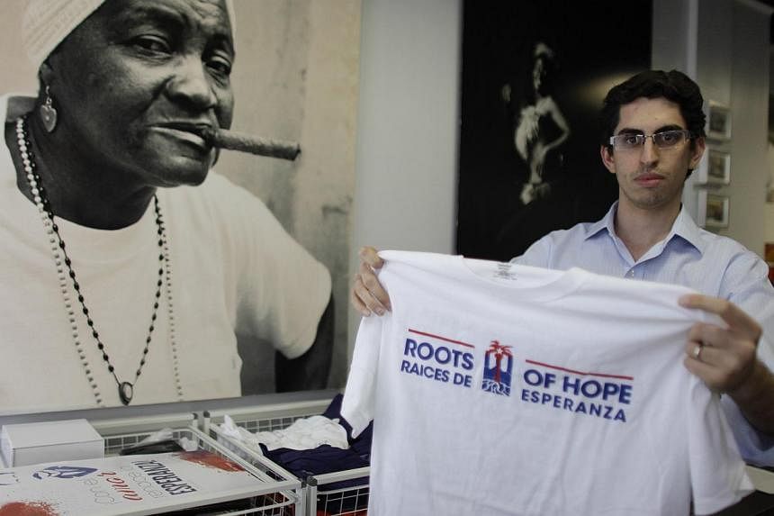 Raul Moas holds a T-shirt of his organisation "Roots of Hope" in Miami Beach, Florida ove the weekend. The Obama Administration's new policy on Cuba is banking on a groundswell of support from new voices in Miami, the young Cuban professionals who do