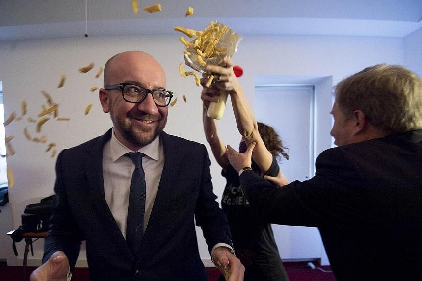 Pierre Rion (right) tries to intervene as activists throw fries and mayonnaise on Belgian Prime Minister Charles Michel, a protest action of feminist activists LilithS (formerly the Belgian branch of Femen), at a conference &nbsp;at the Cercle de Wal