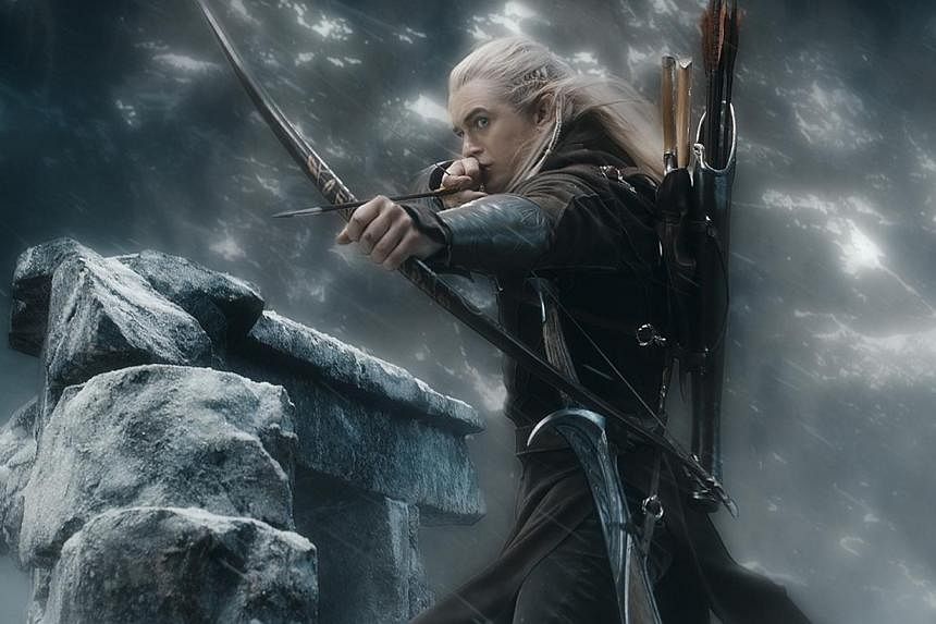 Orlando Bloom as Legolas fires an arrow as The Hobbit: The Battle Of The Five Armies heated up the holiday season box office in the United States and Canada. -- PHOTO: WARNER BROS