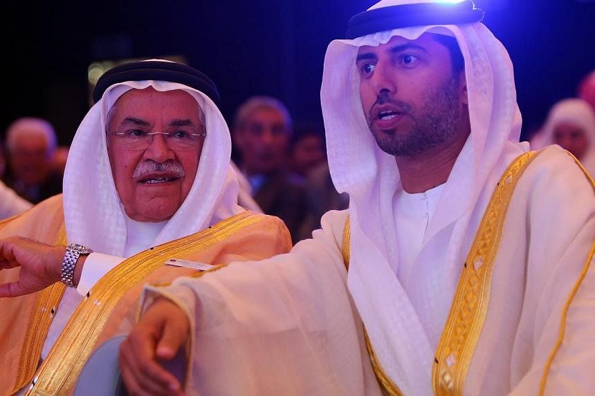 Saudi Oil Minister Ali al-Naimi (left) speaks with United Arab Emirates Energy Minister Suhail bin Mohamed al-Mazroui (right) during the opening session of the 10th Arab Energy Conference in Abu Dhabi, on Sunday. -- PHOTO: AFP