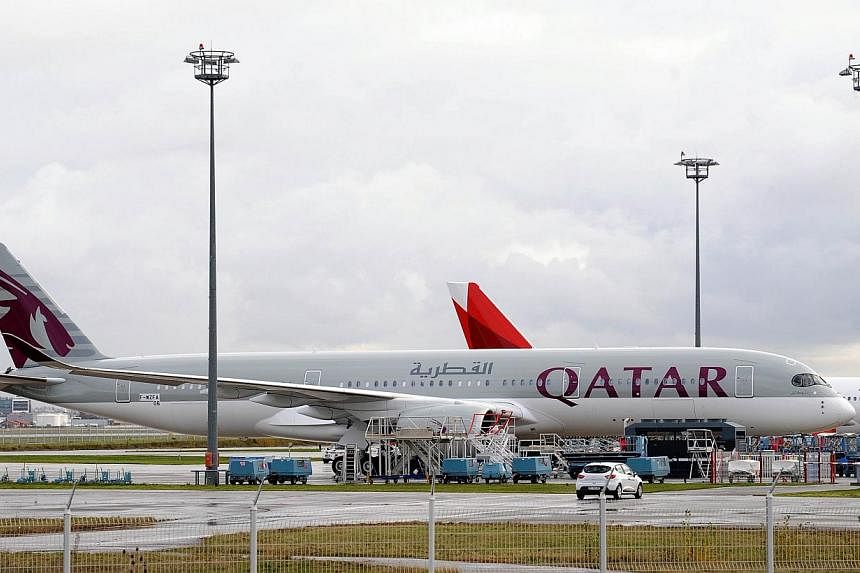 A photo taken on Dec 11, 2014, shows the first Airbus A-350 bearing the Qatar airline company logo on the tarmac of Toulouse Blagnac airport, south-western France. -- PHOTO: AFP
