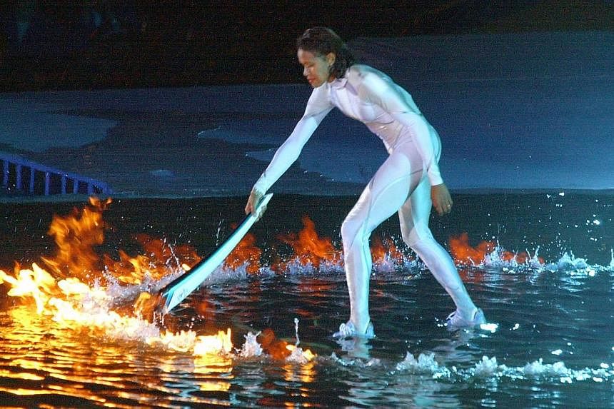 A file photo taken on Sept 15, 2000 shows Australian sporting icon Cathy Freeman lighting the Olympic cauldron in Sydney to ignite the 27th Olympiad of the modern era, and the first of the new millennium.&nbsp;One of Australia's greatest sporting mys