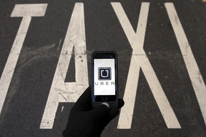Taiwan has slapped a string of fines on app-based taxi service Uber for operating illegally, the latest blow to the US company which is embroiled in a number of international disputes. -- PHOTO: REUTERS