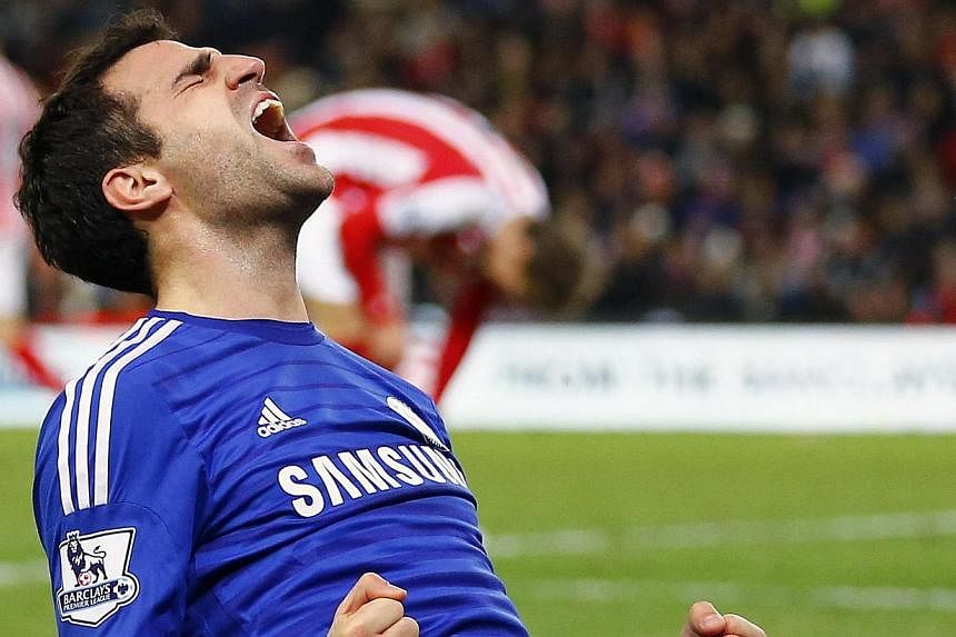 Chelsea's Cesc Fabregas celebrates after scoring the second goal during their English Premier League match against Stoke City at the Britannia Stadium in Stoke-on-Trent on Dec 22, 2014. -- PHOTO: REUTERS