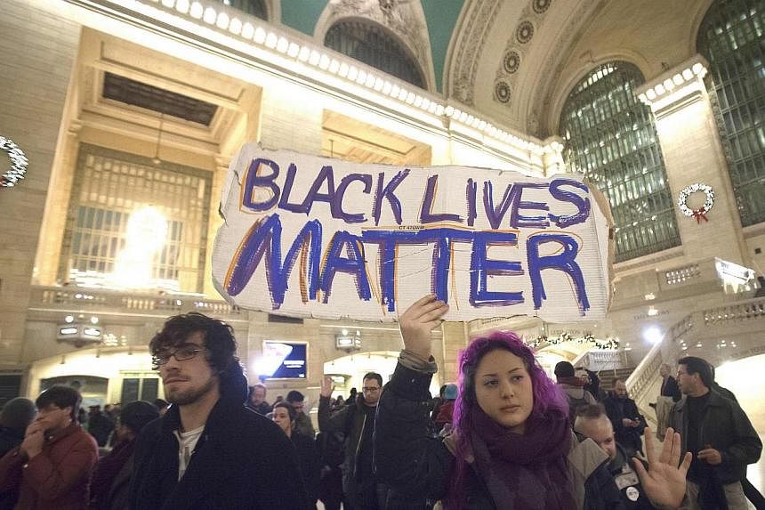Demonstrators protest to demand justice for the death of African-American Eric Garner at Grand Central Terminal in the Manhattan borough of New York, on Dec 9, 2014. Milwaukee police officer Christopher Manney is the latest in a series of white polic