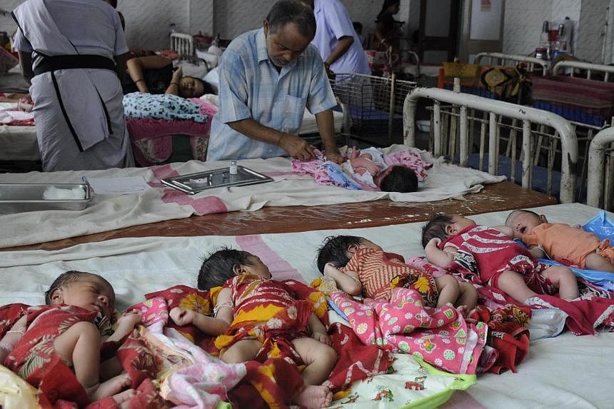 An Indian health official (centre) immunises newly born babies inside the maternity ward of a government hospital in Agartala, the capital of northeastern state of Tripura. India's birth rate declined dramatically in the last two decades due in part 