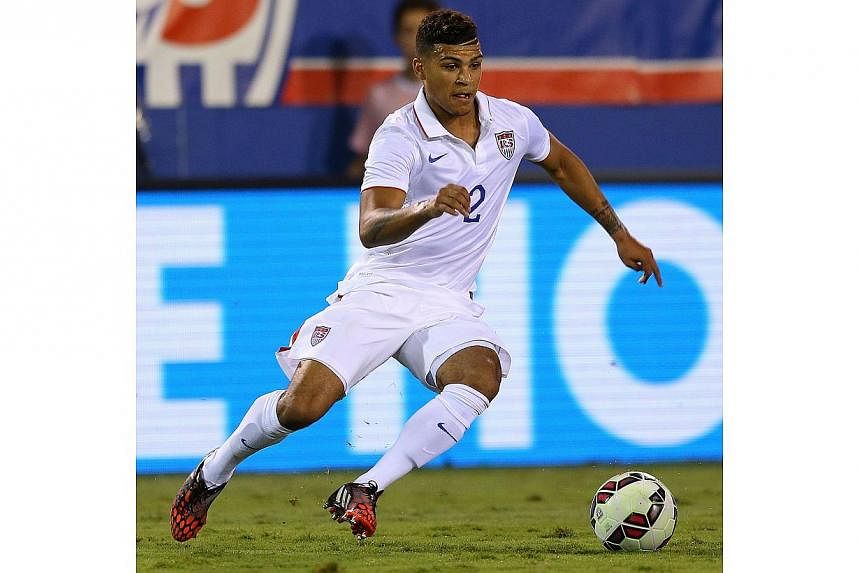 DeAndre Yedlin of the USA brings the ball upfield during a game against Honduras at FAU Stadium on Oct 14, 2014, in Boca Raton, Florida. Yedlin is joining Tottenham in January, the north London football club announced on Tuesday. -- PHOTO: AFP