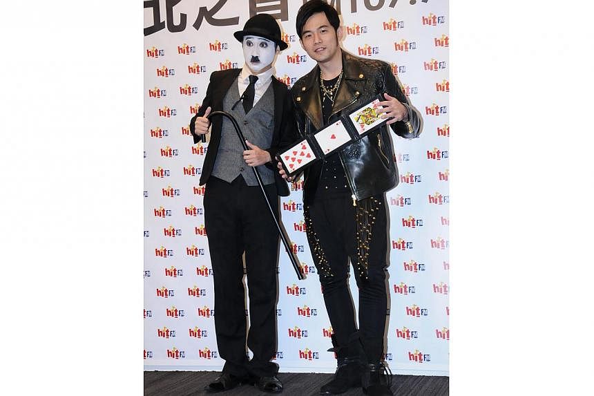 Jay Chou on Monday posing with a Charlie Chaplin impersonator while promoting his new album and Chaplin-inspired music video. -- PHOTO: XINHUA&nbsp;