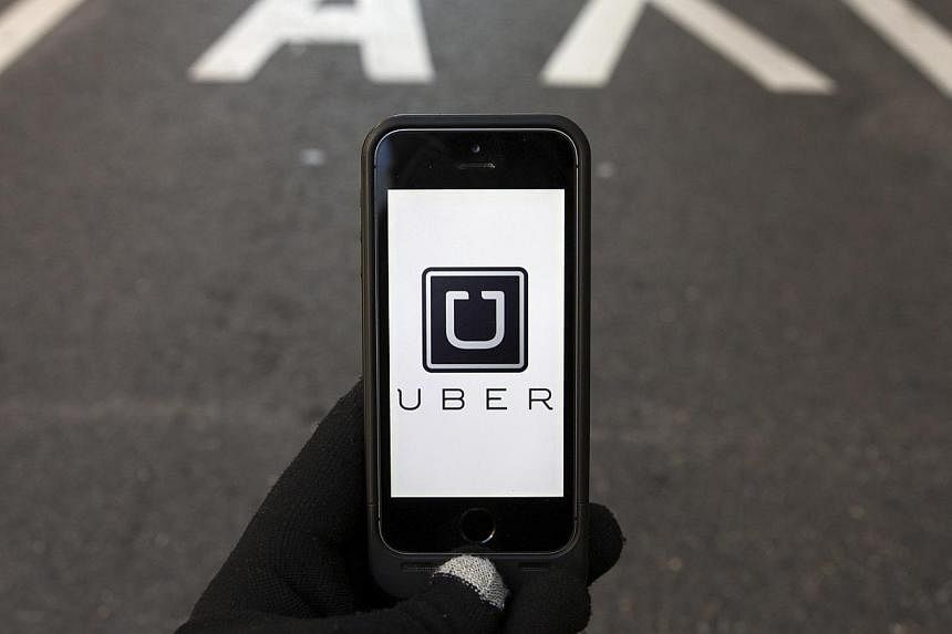 The logo of car-sharing service app Uber on a smartphone. South Korean prosecutors have indicted the local subsidiary of United States taxi-hailing service provider Uber Technologies for violating a law governing public transport. -- PHOTO: REUTERS&n