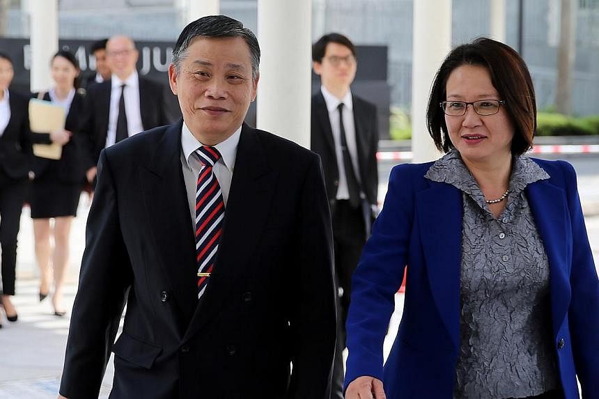 Workers' Party Chairman Sylvia Lim and her Lawyer Peter Low arriving at court on Dec 24, 2014. -- ST PHOTO: WONG KWAI CHOW