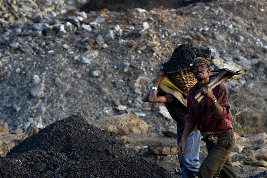 In this file photograph taken on Jan 31, 2013, miners exit the shaft of a coal mine near Mulang village in the Indian northeastern state of Meghalaya.&nbsp;Indian Prime Minister Narendra Modi resorted to a rarely-used executive decree on Wednesday to