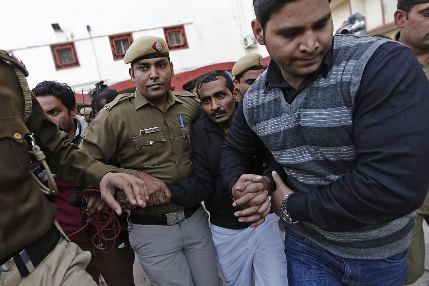 Policemen escort driver Shiv Kumar Yadav (third, right, in black jacket) who is accused of a rape outside a court in New Delhi on Dec 8, 2014. -- PHOTO: REUTERS
