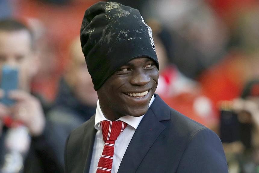 Liverpool's Mario Balotelli smiles before their English Premier League soccer match against Arsenal at Anfield in Liverpool, northern England Dec 21, 2014. Balotelli will return to Liverpool's squad for the festive programme but manager Brendan Rodge