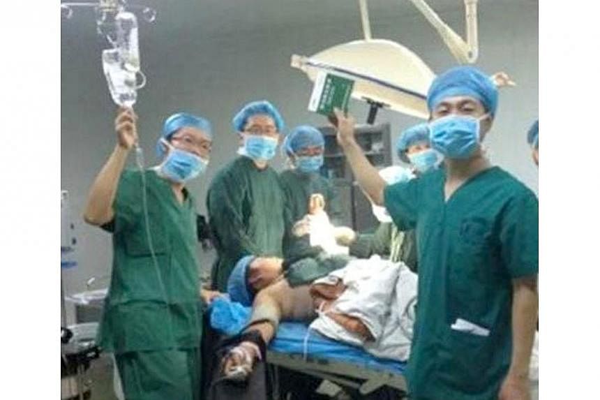 Surgeons in a hospital in China's northwestern city of Xi'an taking a selfie. The patient who appeared in the controversial selfies taken by surgeons in a hospital in China's northwestern city of Xi'an said he was aware of what the doctors were doing
