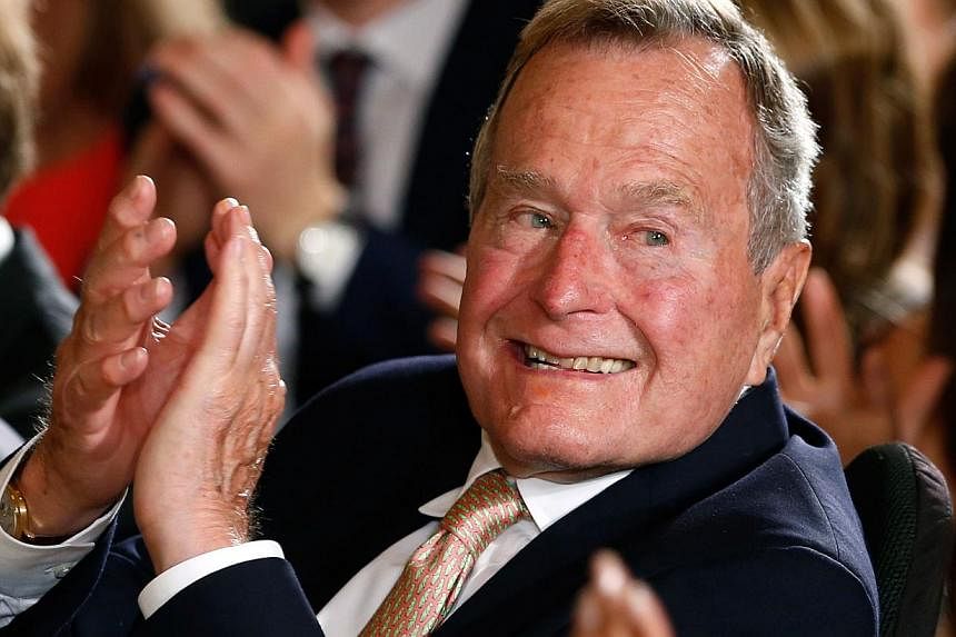 Former President George H. W. Bush applauds during an event to honor the winner of the 5,000th Daily Point of Light Award at the White House in Washington in this July 15, 2013 file image. -- PHOTO: REUTERS&nbsp;