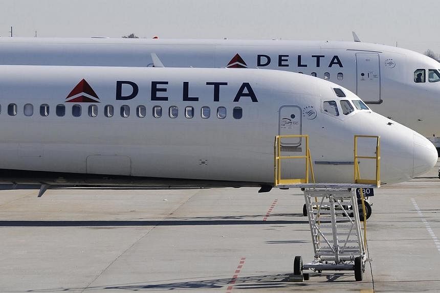Delta Airlines planes wait on the tarmac at Hartsfield-Jackson International Airport in Atlanta, Georgia. One of the airline's baggage handlers and a former employee are among five people indicted in a trafficking ring that transported firemarms, inc