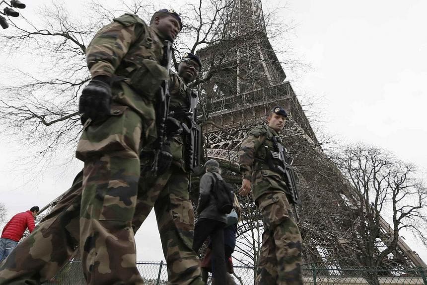 French soldiers patrol near the Eiffel Tower in Paris on Dec 23, 2014. French security forces stepped up protection of public places on Tuesday after three acts of violence in three days left some 30 wounded and reignited fears about France's vulnera