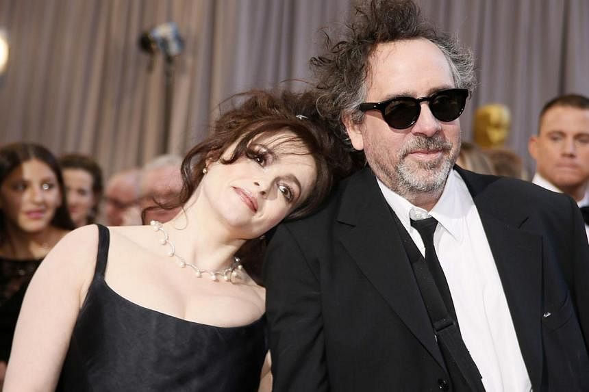 British actress Helena Bonham Carter (left) rests her head on the shoulder of her partner, director Tim Burton, nominee for Director of Best Animated Feature film Frankenweenie, at the 85th Academy Awards in Hollywood, California in this file photo t