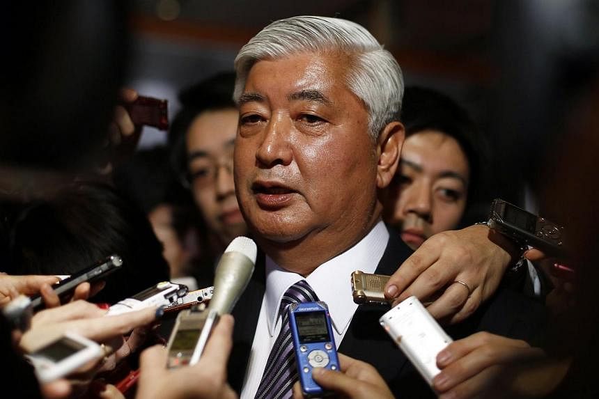 Japan's new Defence Minister Gen Nakatani (pictured) surrounded by reporters at Prime Minister Shinzo Abe's official residence in Tokyo on Dec 24, 2014. -- PHOTO: REUTERS