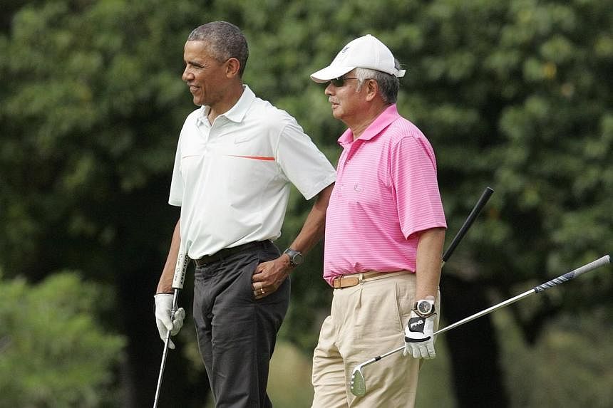 US President Barack Obama and Malaysia's Prime Minister Najib Razak walk off 18th hole while playing a round of golf at the Clipper Golf course on Marine Corps Base Hawaii during Mr Obama's Christmas holiday vacation in Kaneohe, Hawaii, on Dec 24, 20