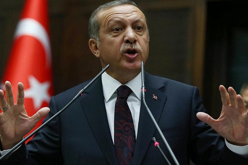 Turkey's Prime Minister Recep Tayyip Erdogan speaking to members of Parliament from his ruling Justice and Development (AKP) Party during a meeting at the Turkish parliament in Ankara on Apr 8, 2014. A high school student has been arrested in central
