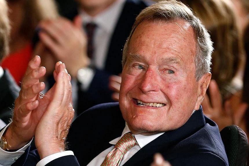 Former US president George H.W. Bush, 90 (above, in a 2013 file photo), remained in a Houston hospital on Wednesday as a precaution after experiencing a shortness of breath, a spokesman for the 41st president said. -- PHOTO: REUTERS