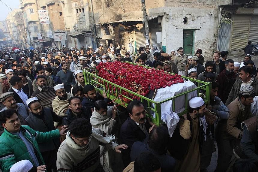 People carry the coffin of a male student killed in a school attack carried out by Taleban gunmen, during his funeral in Peshawar, Dec 17, 2014.&nbsp;Pakistani leaders have agreed to establish military courts for terrorism-related cases, after meetin