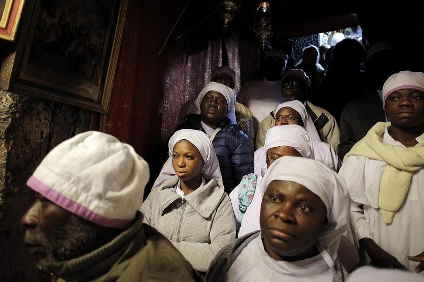 Nigerian pilgrims pray inside the Grotto, where Christians believe the Virgin Mary gave birth to Jesus, during Christmas celebrations at the Church of the Nativity in the West Bank town of Bethlehem Dec 24, 2014. -- PHOTO: REUTERS