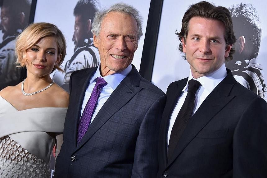 (From left) Sienna Miller, Clint Eastwood and Bradley Cooper arrive at the American Sniper New York Premiere at Frederick P. Rose Hall, Jazz at Lincoln Center in New York City on Dec 15, 2014. -- PHOTO: AFP&nbsp;
