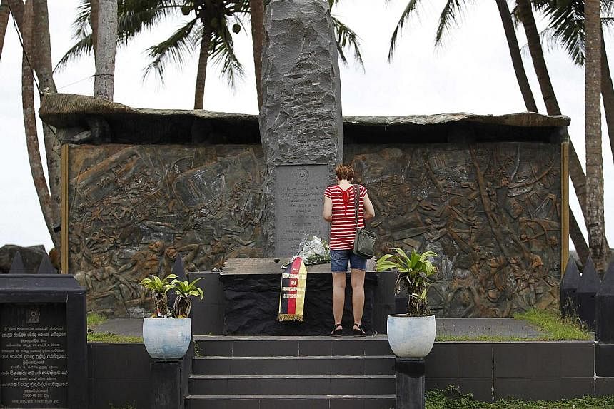 A tourist standing in front of the Tsunami memorial in Pereliya, Sri Lanka, on Dec 20, 2014. More than 250,000 people died in the tsunami on Dec 26, 2004. Indonesia bore the brunt, but Sri Lanka was the next worst-affected country with a death toll o