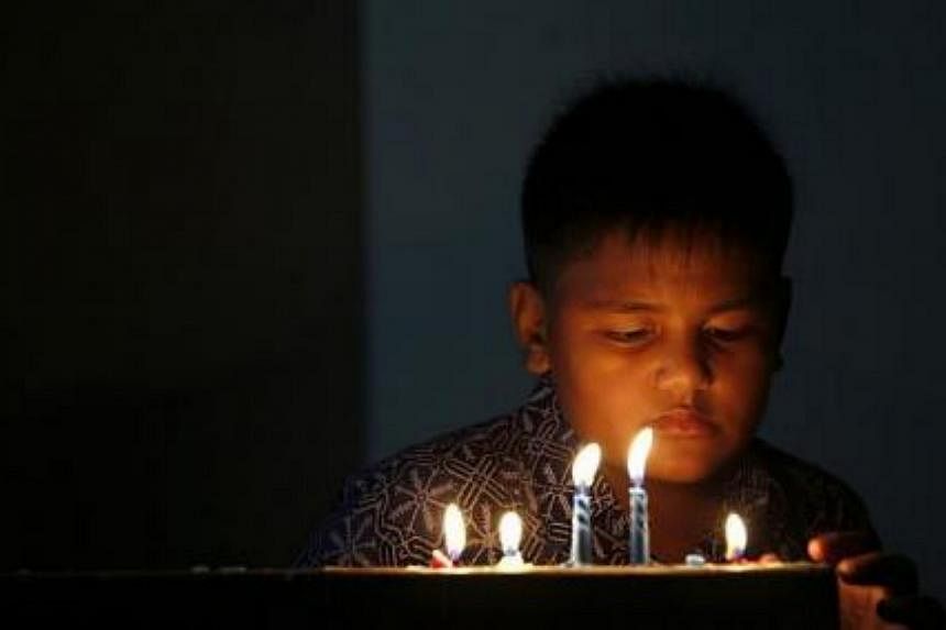 A child attends a mass during Christmas eve at HKBP church in Banda Aceh, on Dec 24, 2014. -- PHOTO: REUTERS
