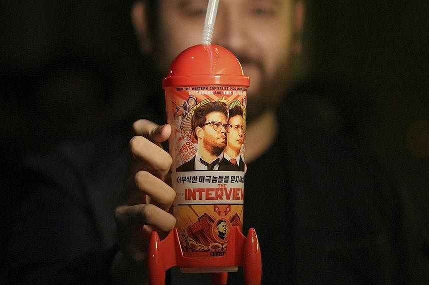 The poster for the movie The Interview on Dec 25, 2014, is seen on the marquee of the Los Feliz 3 cinema in Los Angeles, California. -- PHOTO: AFP