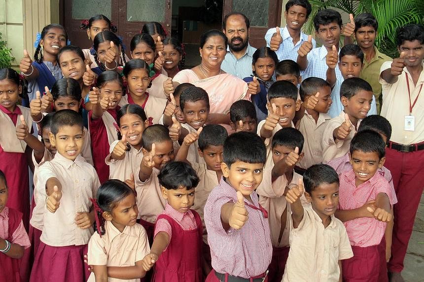 When he lost his three children to the tsunami on what was his 40th birthday, engineer K Parameswaran (in blue shirt) and wife Choodamani (in peach sari) opened their large home to children orphaned by the hungry tide. They now have 37 wards, includi