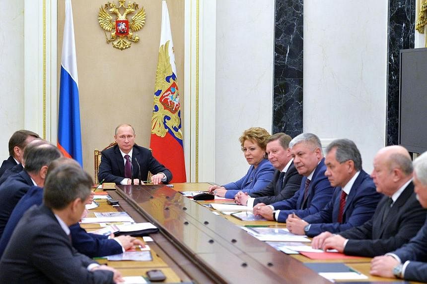 Russian President Vladimir Putin (middle) chairs a Security Council meeting at the Kremlin in Moscow on Dec 26, 2014. -- PHOTO: AFP