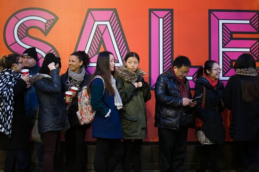 Shoppers queue outside Selfridges department store before it opens in central London, on Dec 26, 2014, for the post-Christmas, Boxing Day sales. -- PHOTO: AFP&nbsp;