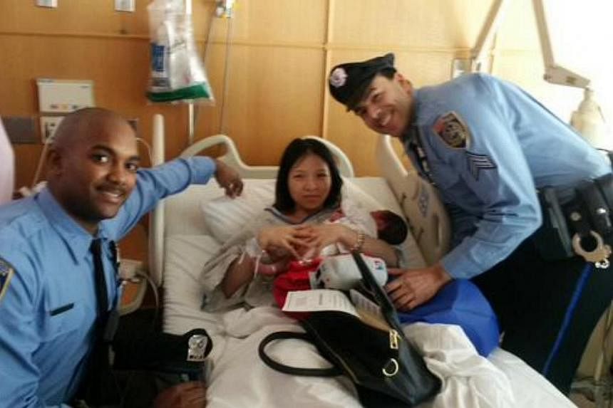 Mum Yanjin Li and the two officers who helped to deliver her baby when she went into labour on the Philadelphia subway are pictured with baby "Chris" in a new tweet from the Southeastern Pennsylvania Transportation Authority. -- PHOTO: TWITTER