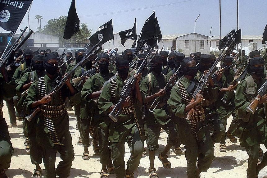 A file photo taken on Feb 17, 2011 shows Islamist fighters loyal to Somalia’s Al-Qaeda&nbsp;inspired Al-Shebab&nbsp;group performing military drills at a village in Lower Shabelle region, some 25 kilometres outside Mogadishu. -- PHOTO: AFP