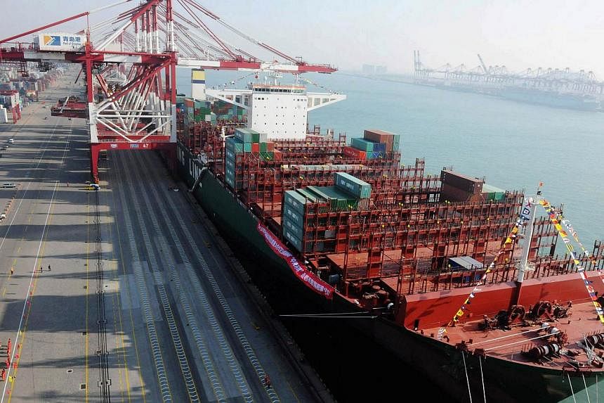 This picture taken on December 4, 2014 shows the China Shipping Container Lines Co.Ltd (CSCL) Globe berthing in Qingdao port during its maiden voyage to Europe in Qingdao, east China's Shandong province.&nbsp;PHOTO: AFP